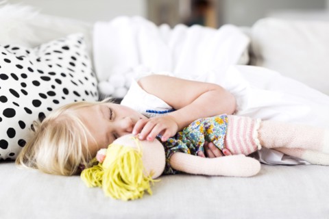 Girl (2-3) napping on sofa