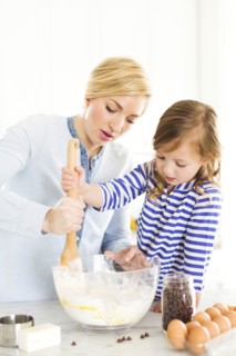 Mother and daughter (4-5) baking