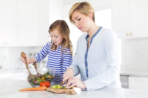 Mother and daughter (4-5) preparing salad