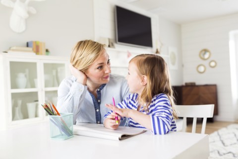 Girl (4-5) drawing with her mom
