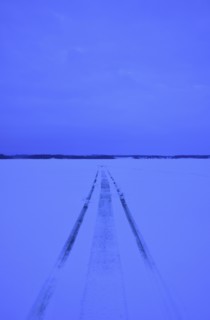 Snowmobile tracks on frozen lake