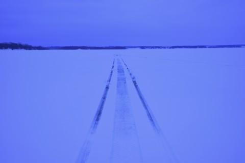 Snowmobile tracks on frozen lake