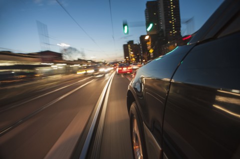 Car speeding along railroad tracks