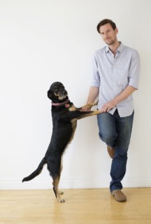 Man playing with dog.
