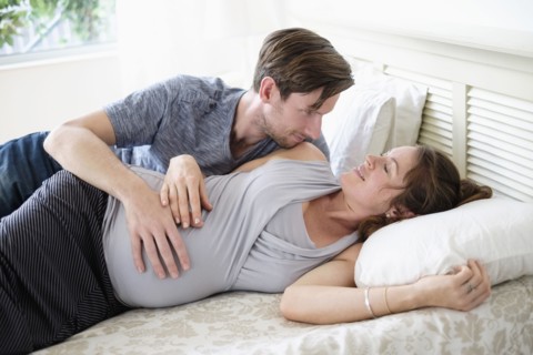Couple lying in bed.