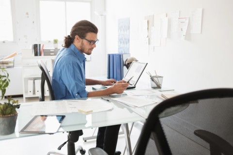 Mid-adult man working in office.
