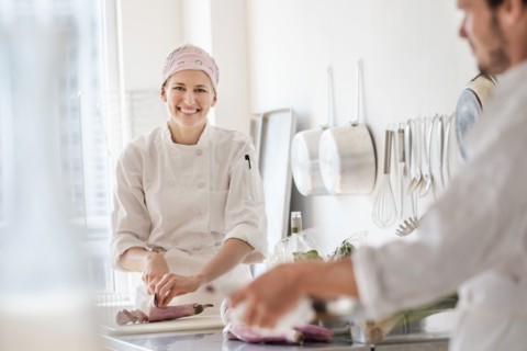 Chefs working in kitchen.