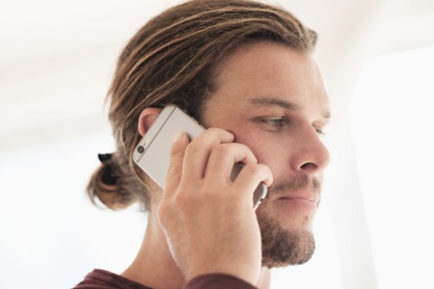 Mid-adult man talking on phone.