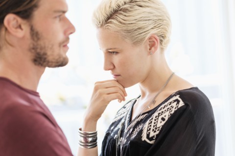 Couple arguing in living room.