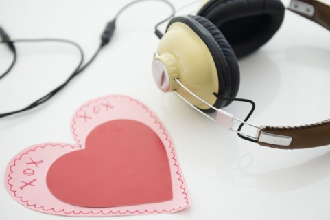 Studio shot of heart shaped paper cutout and headphones