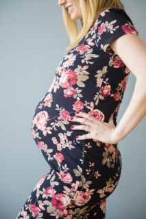 Studio shot of pregnant woman in floral dress