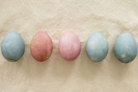 Dyed Easter eggs in a row on beige