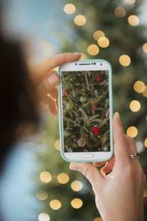 Personal perspective of person photographing Christmas tree