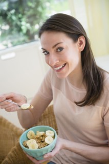 Woman at home eating healthy breakfast