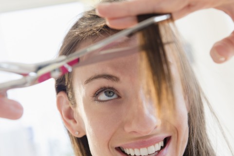 Woman cutting her hair