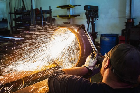 Welder working in metal workshop