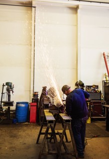 Welder working in metal workshop