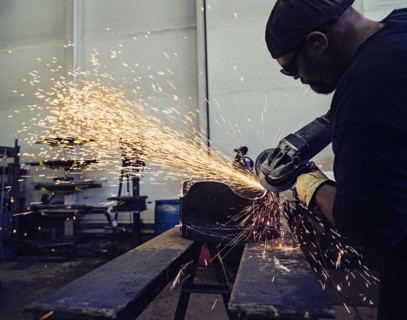 Welder working in metal workshop