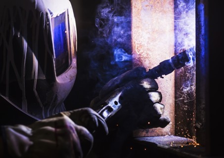 Man in welding mask working