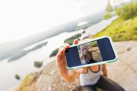 Young woman taking selfie on Smartphone
