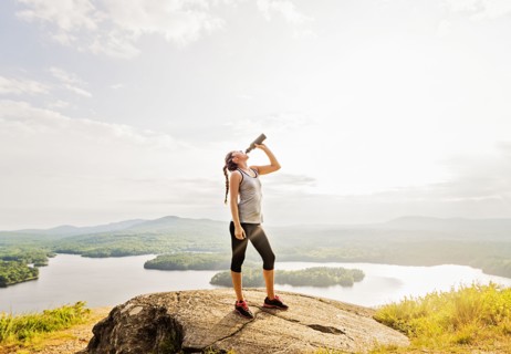Woman drinking water after doing exercises