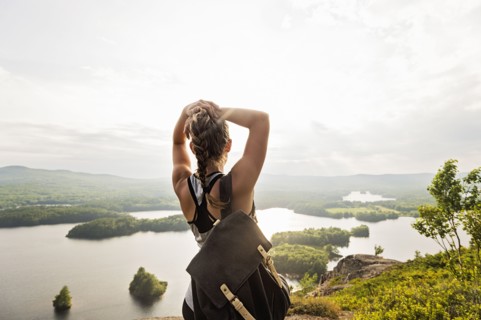 Rear view of young woman looking at lake