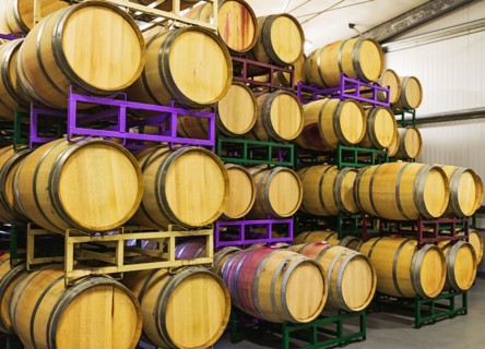 Wine barrels on racks in cellar