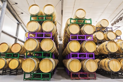 Wine barrels on racks in cellar