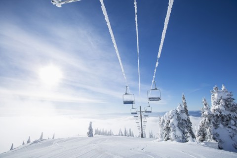 Ski lift at sunlight against blue ski