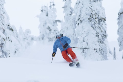 Mature man speeding on ski slope