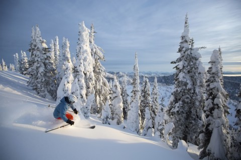 Mature man on ski slope at sunset