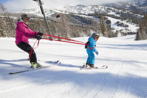 Mother teaching son (4-5) how to ski