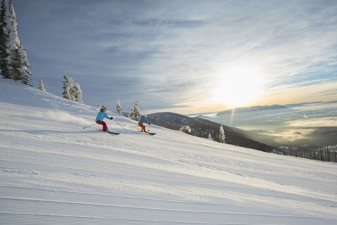 Couple skiing at sunset