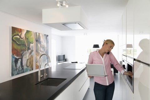Woman with laptop in kitchen