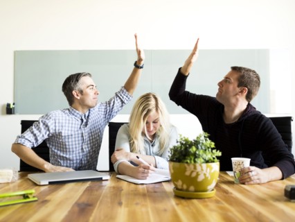Office workers witting and working at desk