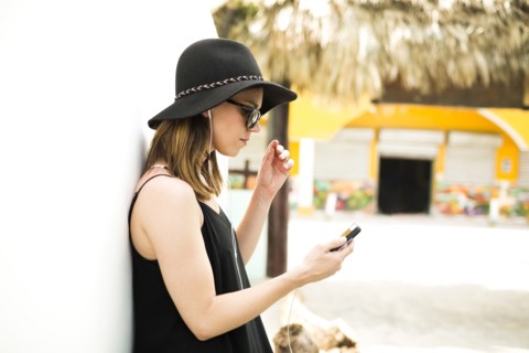 Portrait of woman wearing hat and sunglasses