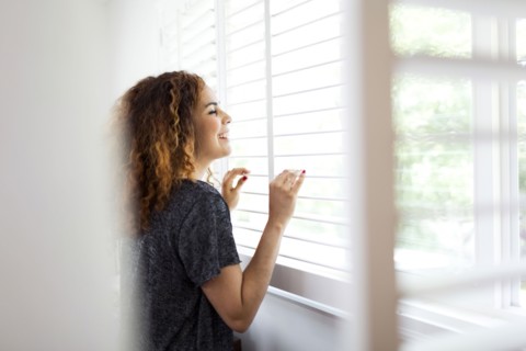 Woman looking through window