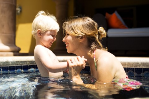 Mother with son (2-3) in swimming pool