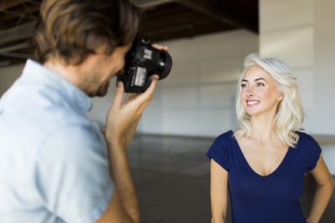 Man photographing woman