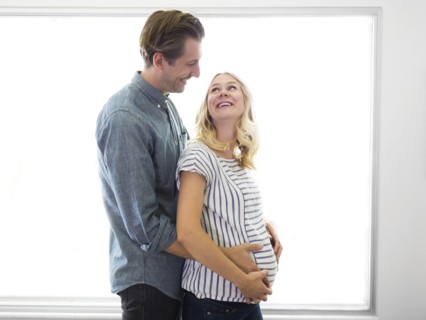 Husband embracing pregnant wife
