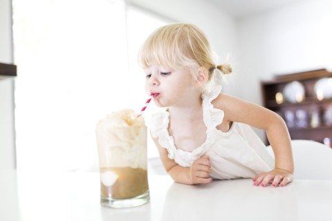Girl (2-3) drinking milkshake
