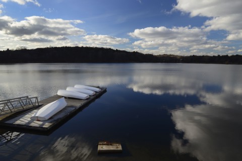 Cloud reflection over boat dock Jamaica Pond