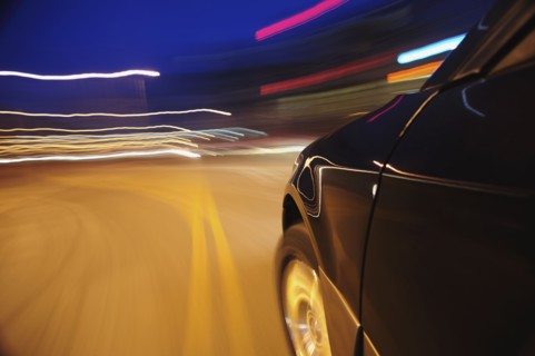 Car speeding at dusk