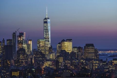 Illuminated skyline at sunrise. New York City, New York, USA.