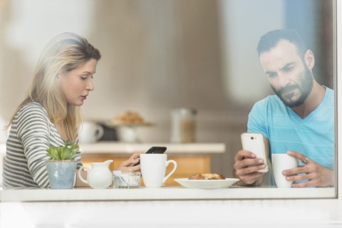 Woman and man using telephones.