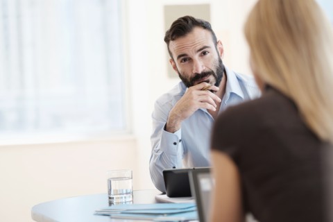 Man and woman sitting in office.