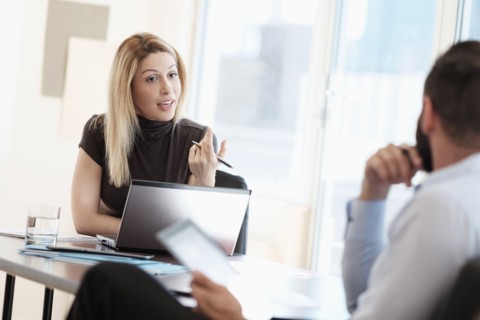 Man and woman talking in office.