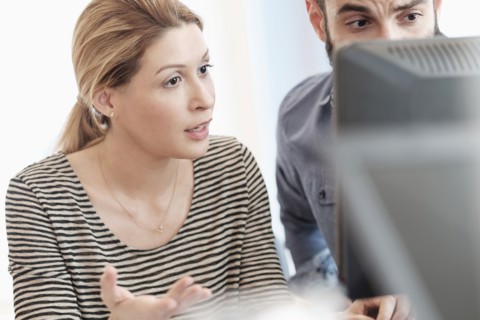 Man and woman looking at computer.