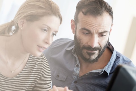Man and woman looking at computer.