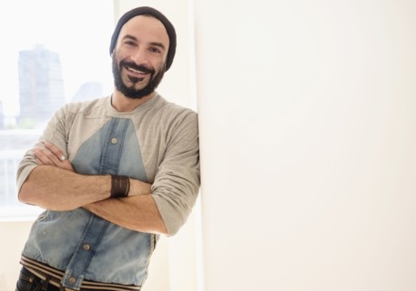 Portrait of man leaning on wall.
